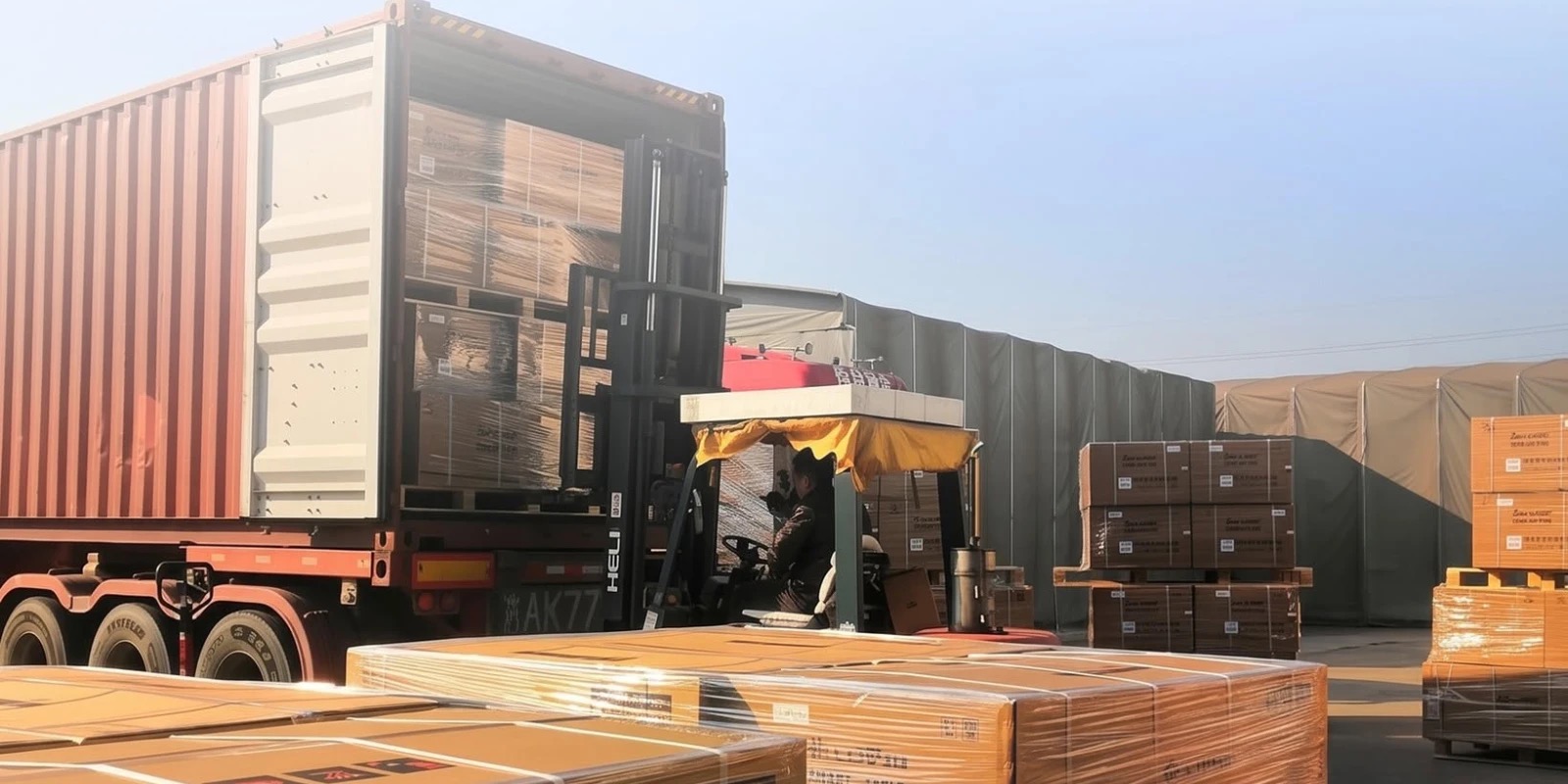 Forklift unloading palletized cargo from a shipping container